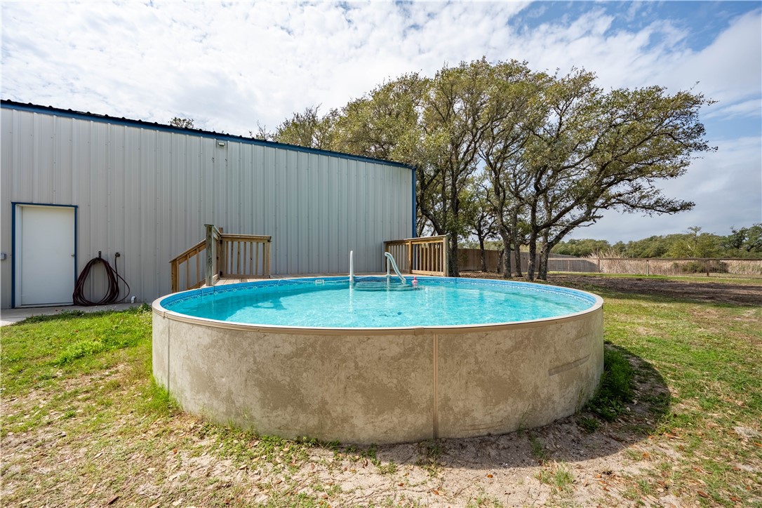 1511 Monkey Road Rockport, TX 78382 - Photo 32 of 40 a view of a swimming pool with a yard