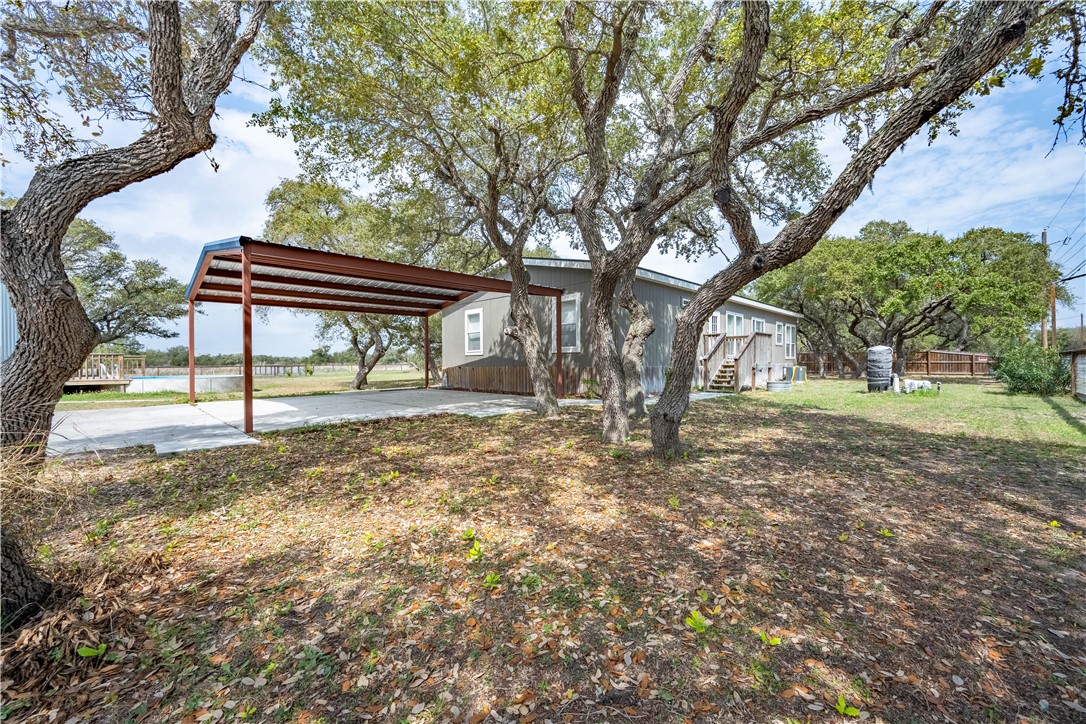 1511 Monkey Road Rockport, TX 78382 - Photo 4 of 40 a view of outdoor space with garden and trees