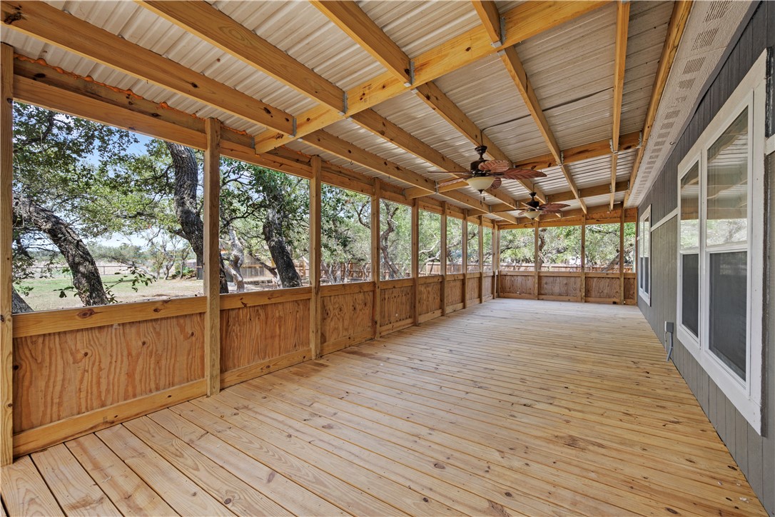 1511 Monkey Road Rockport, TX 78382 - Photo 10 of 40 a view of an empty room with wooden floor and iron stairs
