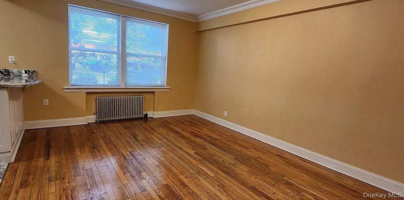 141-39 79th Avenue, Unit 3O Queens, NY 11367 - Photo 5 of 10 a view of room with window and wooden floor