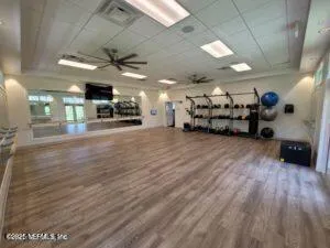 a room with gym equipment and mirrors