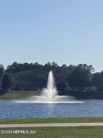 a view of swimming pool with outdoor seating and lake view