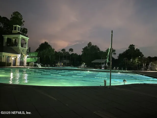 an aerial view of a house with garden space and street view