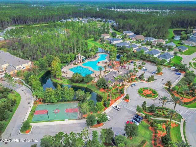 an aerial view of residential house with outdoor space and swimming pool