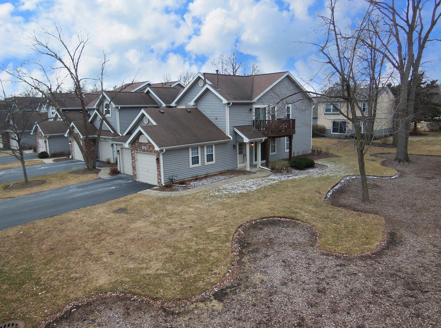 1380 Ridgefield Circle, Unit 1380 Carol Stream, IL 60188 - Photo 1 of 25 a view of a white house next to a road with a house