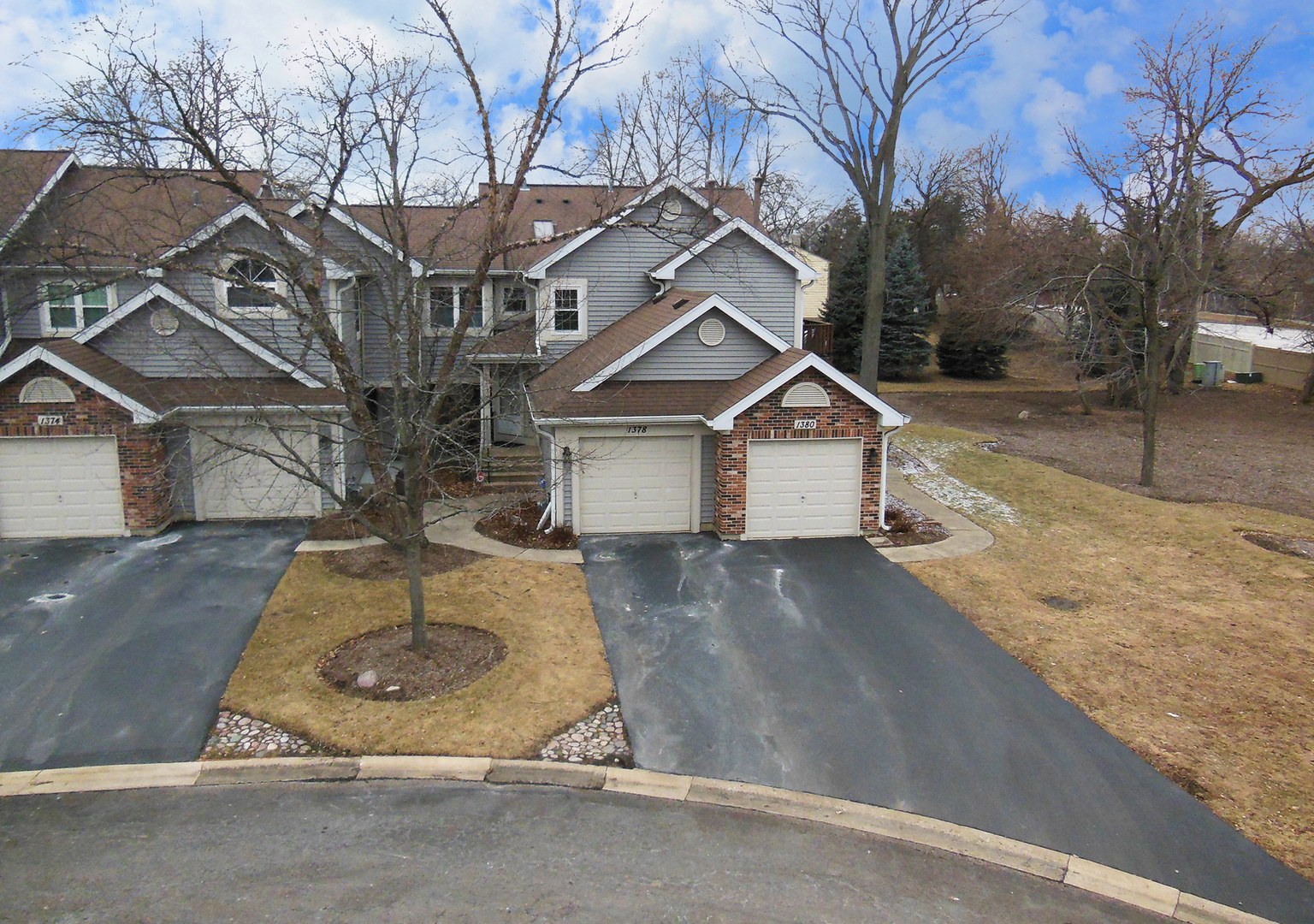 1380 Ridgefield Circle, Unit 1380 Carol Stream, IL 60188 - Photo 3 of 25 a view of a white house next to a road and yard