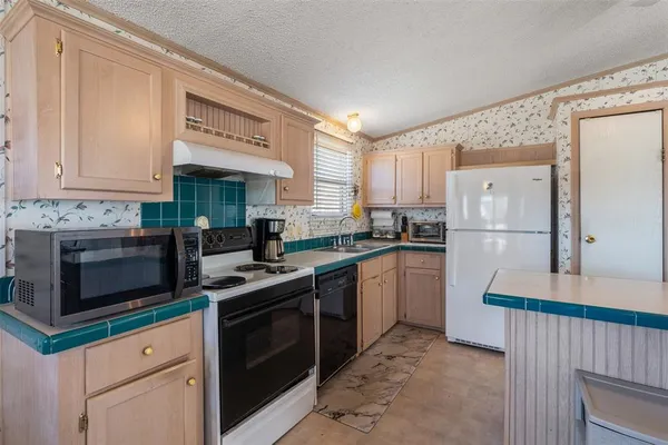 a kitchen with a sink stove and refrigerator