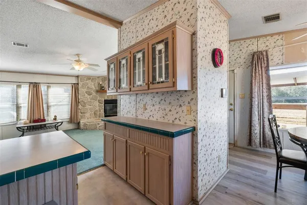 a kitchen with granite countertop a sink stove and refrigerator