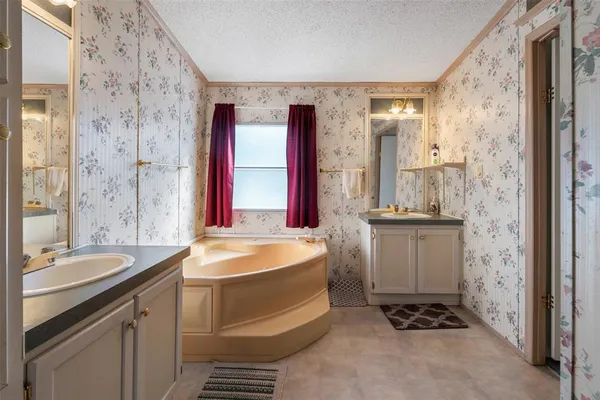 a spacious bathroom with sink shower and a mirror