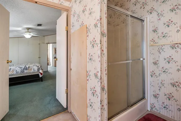 a bedroom with a bed and a view of bathroom