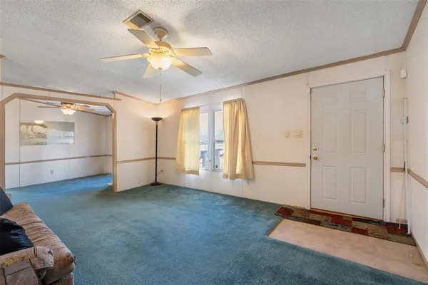 an empty room with closet and windows