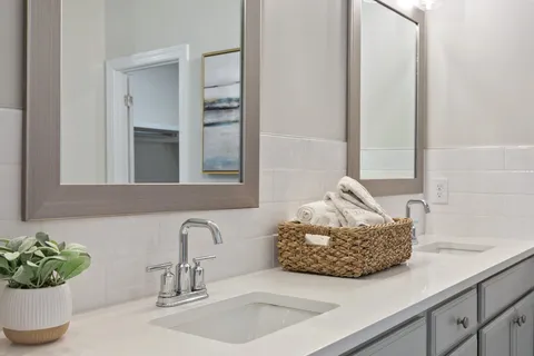 a spacious bathroom with a double vanity sink mirror and toilet
