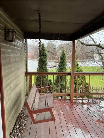 a view of a balcony with wooden floor