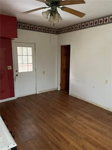 a view of a room with wooden floor