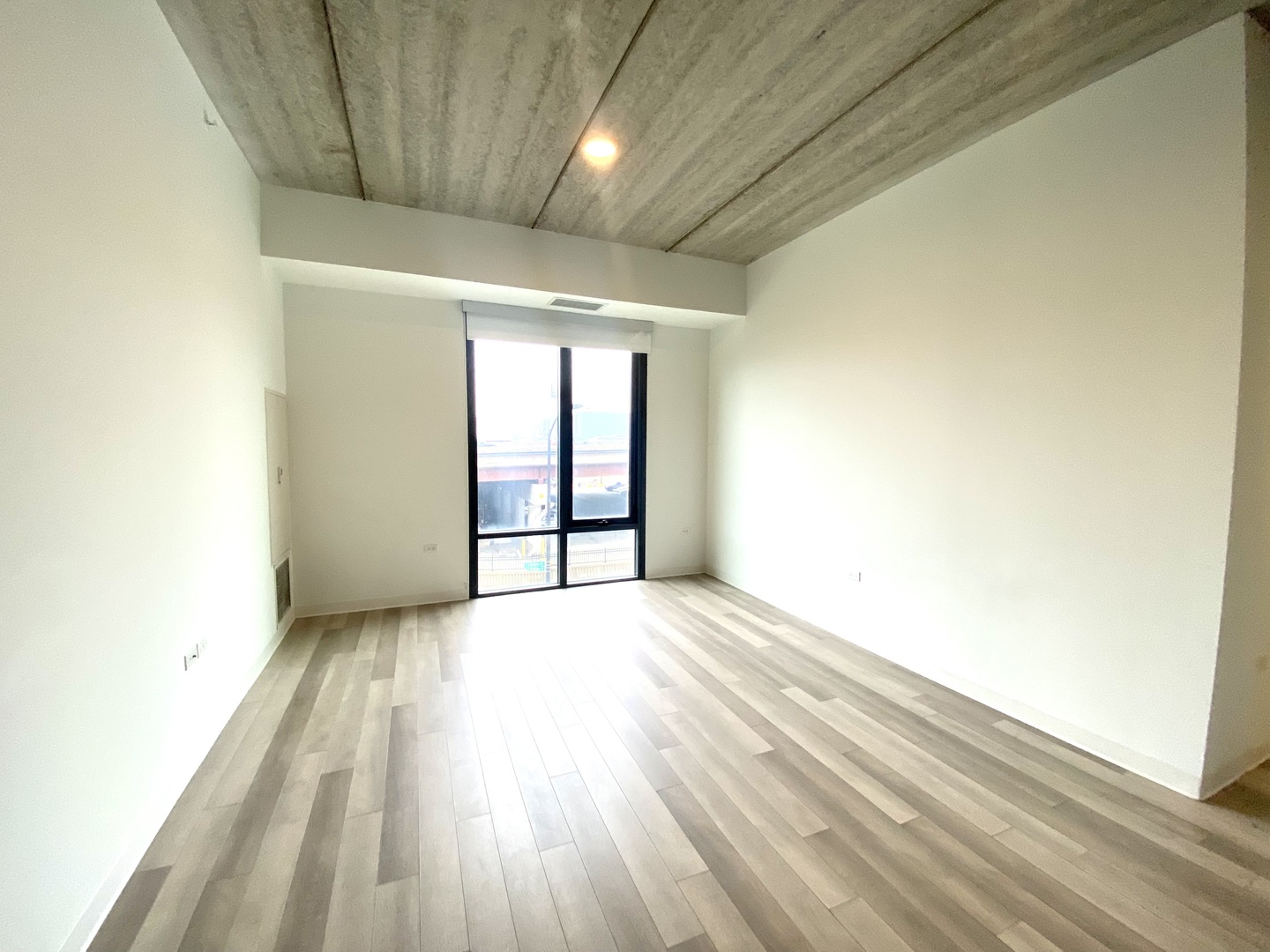 710 West 14th Street, Unit 320 Chicago, IL 60607 - Photo 4 of 7 an empty room with wooden floor and windows