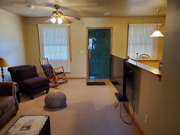 a living room with furniture a chandelier and a window