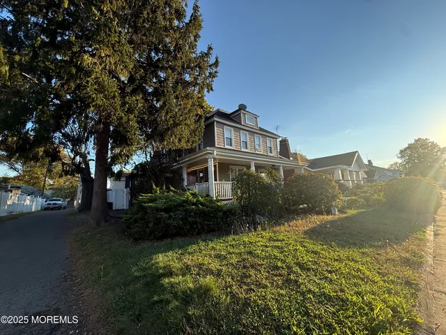 a front view of a house with a yard and fountain