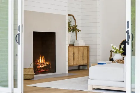 a living room with a fireplace furniture and a window