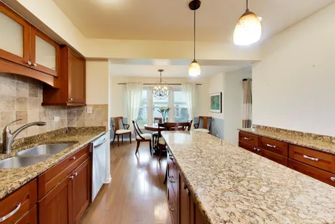 a kitchen with sink stove and cabinets