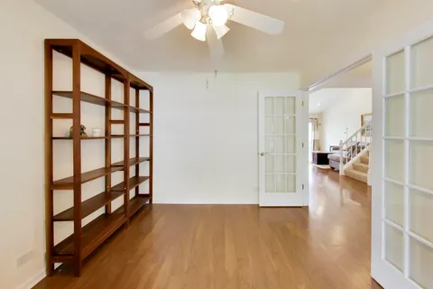 a view of livingroom with hardwood floor and a ceiling fan