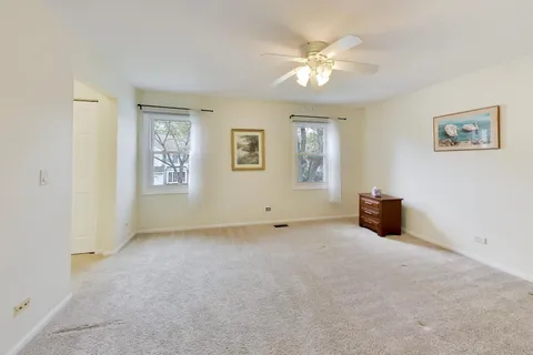 a view of a livingroom with a ceiling fan and window