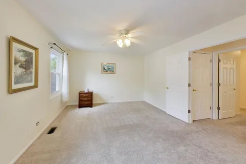 a view of a livingroom with a ceiling fan and window