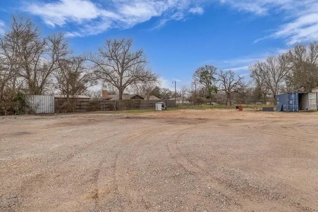 a view of road with large trees