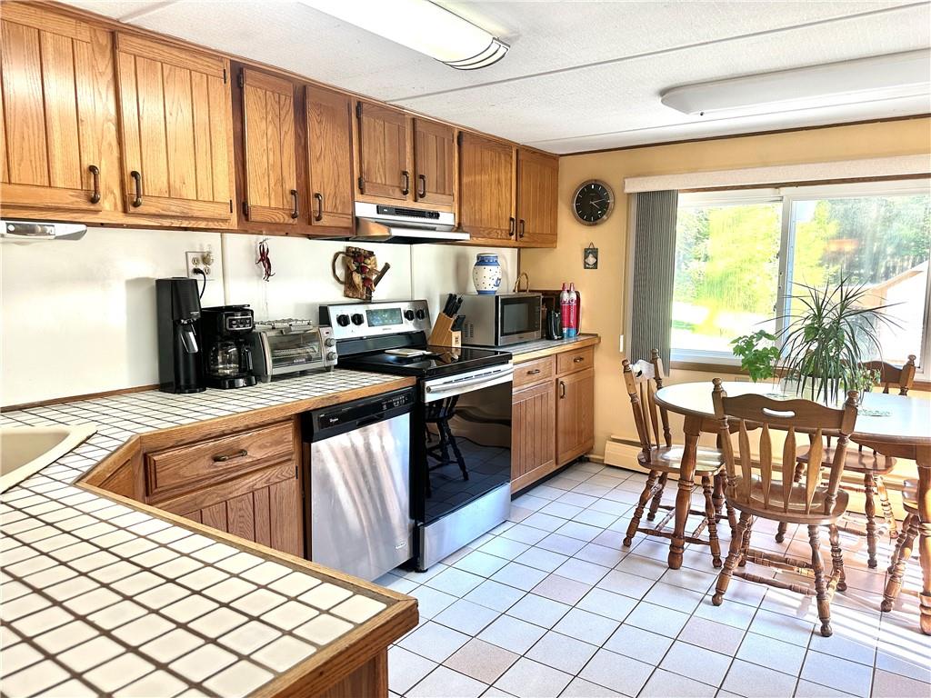 12 Mesmer Hill Road Callicoon, NY 12723 - Photo 7 of 18 Kitchen featuring tile counters, appliances with stainless steel finishes, and light tile floors