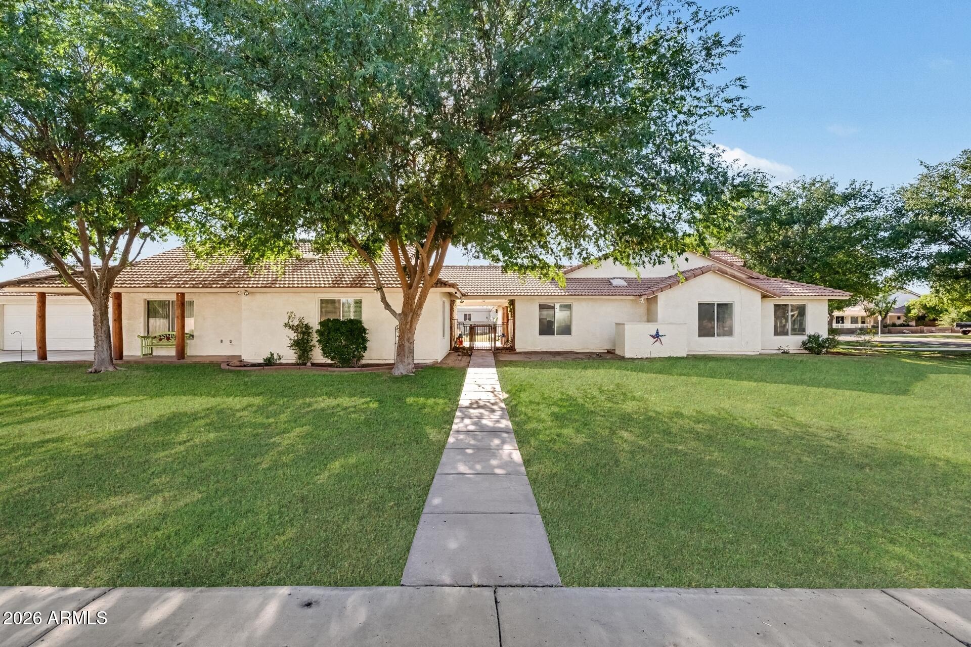 2593 East Ridgewood Lane Gilbert, AZ 85298 - Photo 13 of 23 a front view of a house with a yard