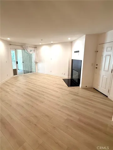 a view of a livingroom with wooden floor and staircase