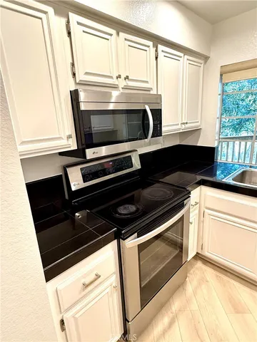 a kitchen with wooden cabinets and a stove top oven