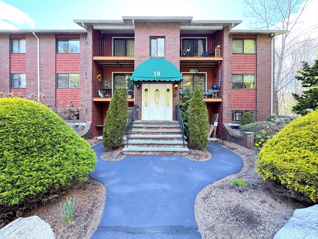 19 Fuller Road, Unit 1 Foxboro, MA 02035 - Photo 1 of 18 a front view of a house with yard