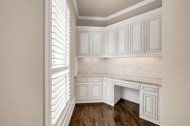 a kitchen with granite countertop white cabinets and white appliances