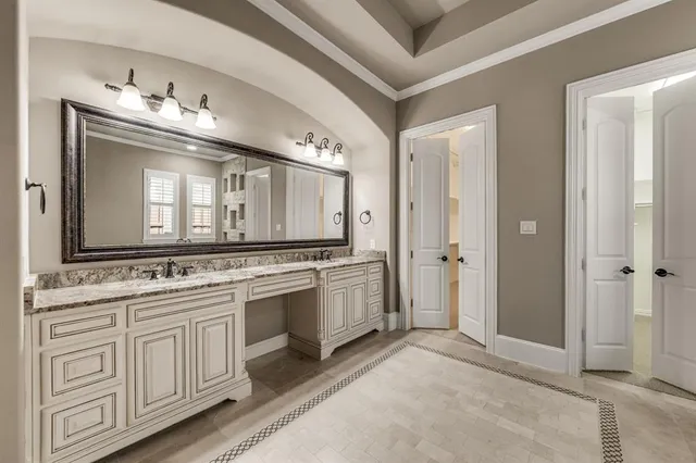 a bathroom with a double vanity sink and a mirror