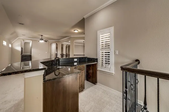 a kitchen with a sink stainless steel appliances a counter top space and cabinets