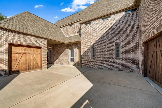 a view of a yard with wooden fence