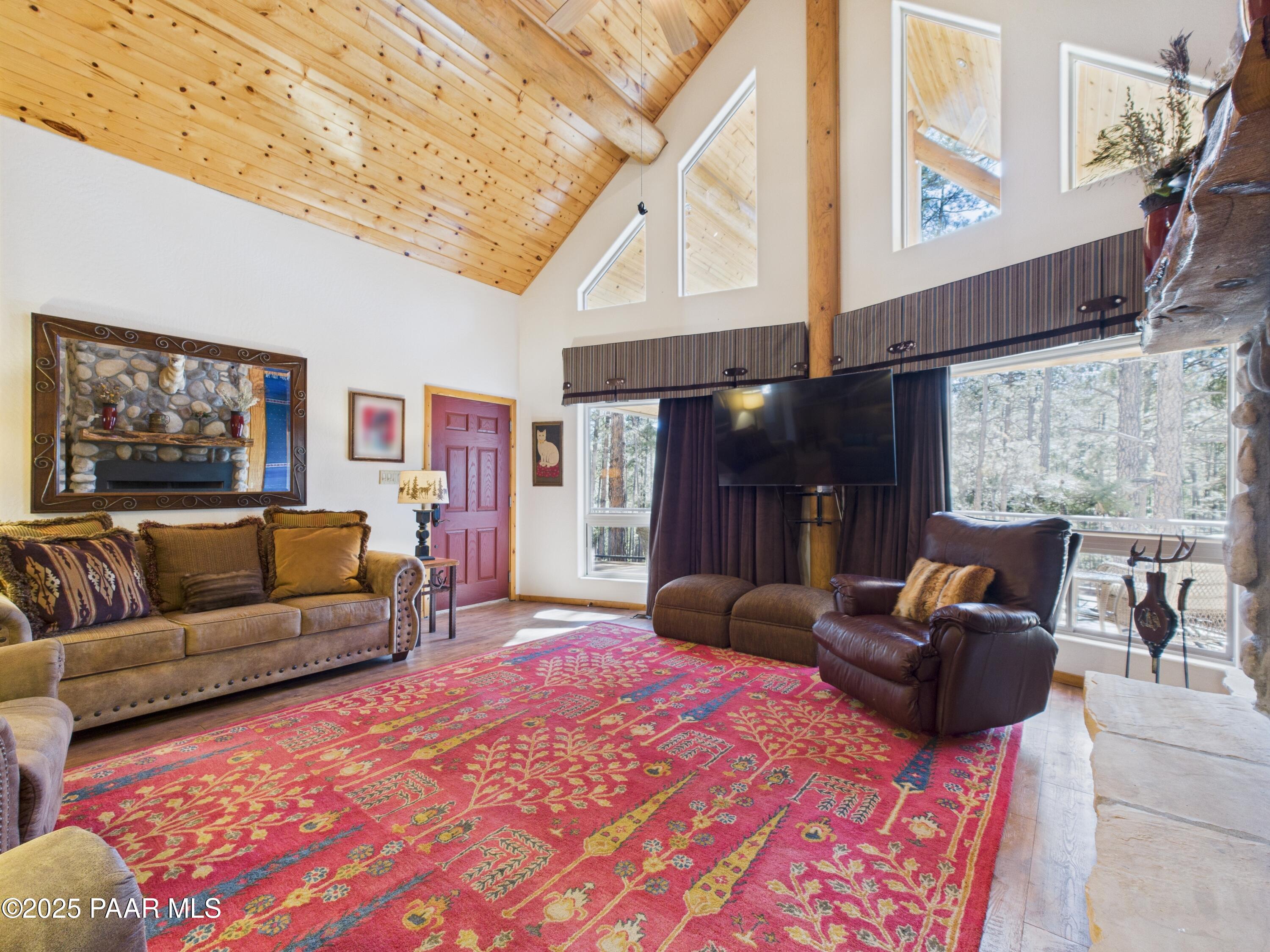 835 Happy Valley Road Prescott, AZ 86305 - Photo 11 of 61 a living room with furniture a flat screen tv and a fireplace