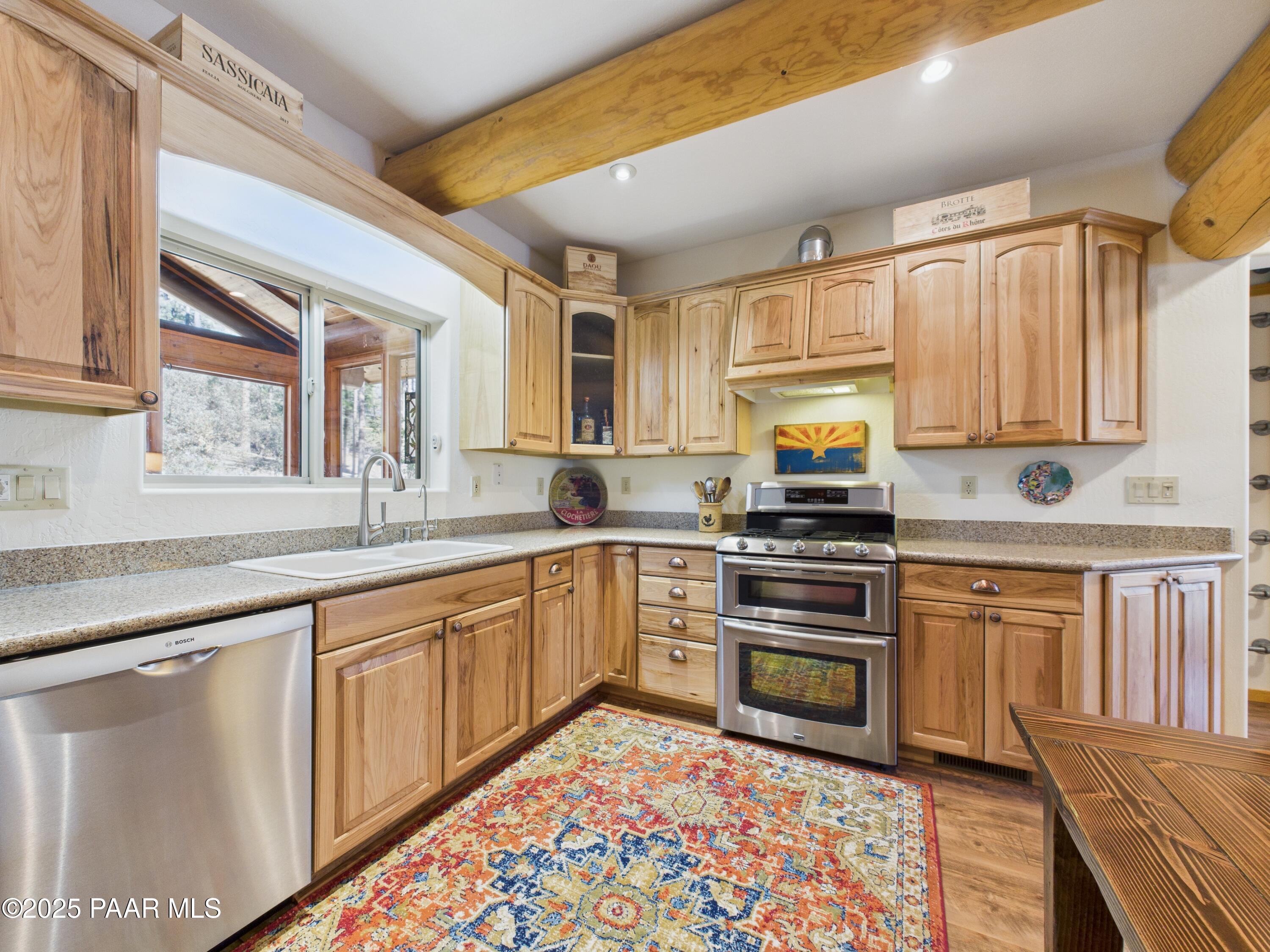 835 Happy Valley Road Prescott, AZ 86305 - Photo 14 of 61 a kitchen with granite countertop a sink stainless steel appliances and cabinets