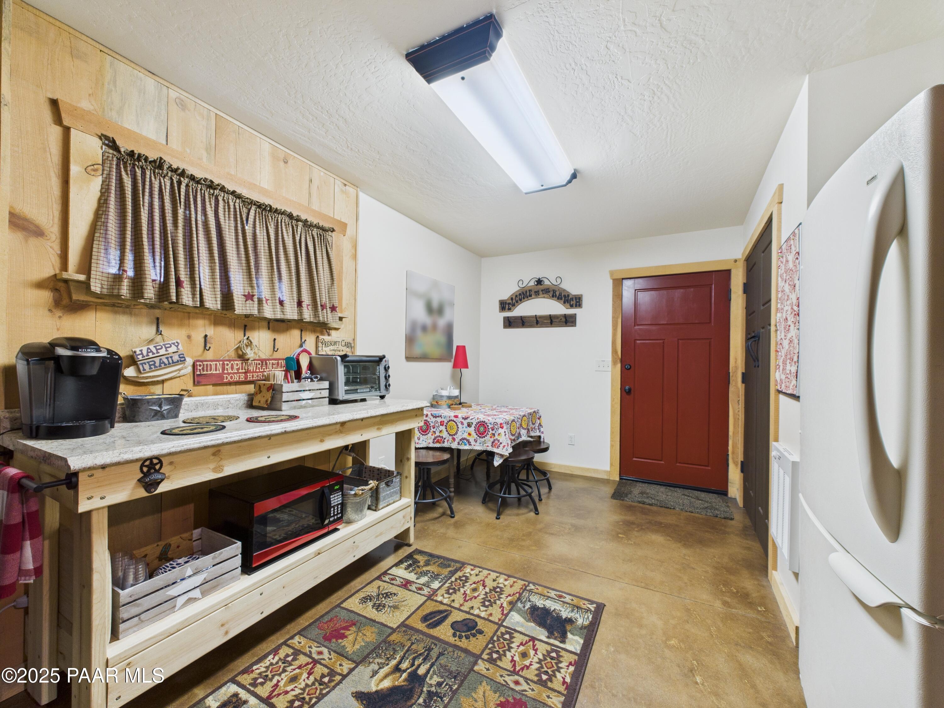 835 Happy Valley Road Prescott, AZ 86305 - Photo 42 of 61 a kitchen with stainless steel appliances granite countertop a stove a sink dishwasher and a refrigerator with wooden floor