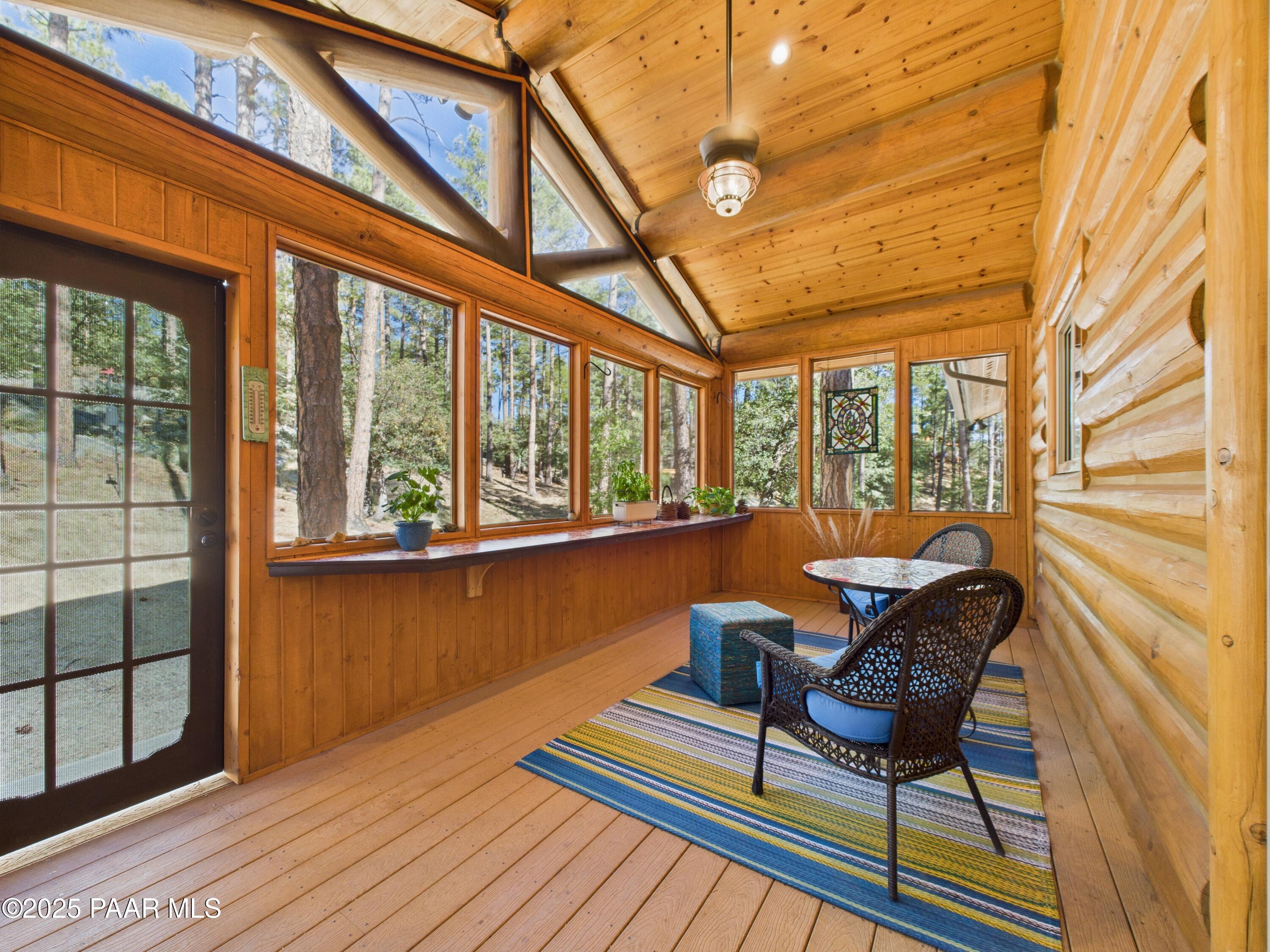 835 Happy Valley Road Prescott, AZ 86305 - Photo 49 of 61 a living room filled with furniture and a floor to ceiling window