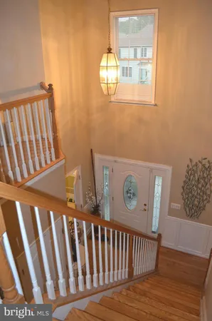 a view of a hallway with wooden floor and a window