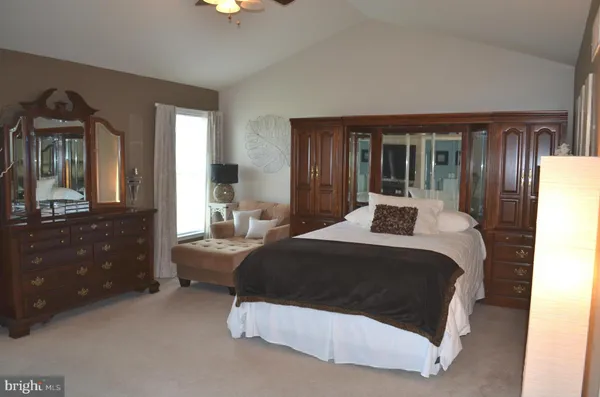 a bedroom with a bed window and dresser