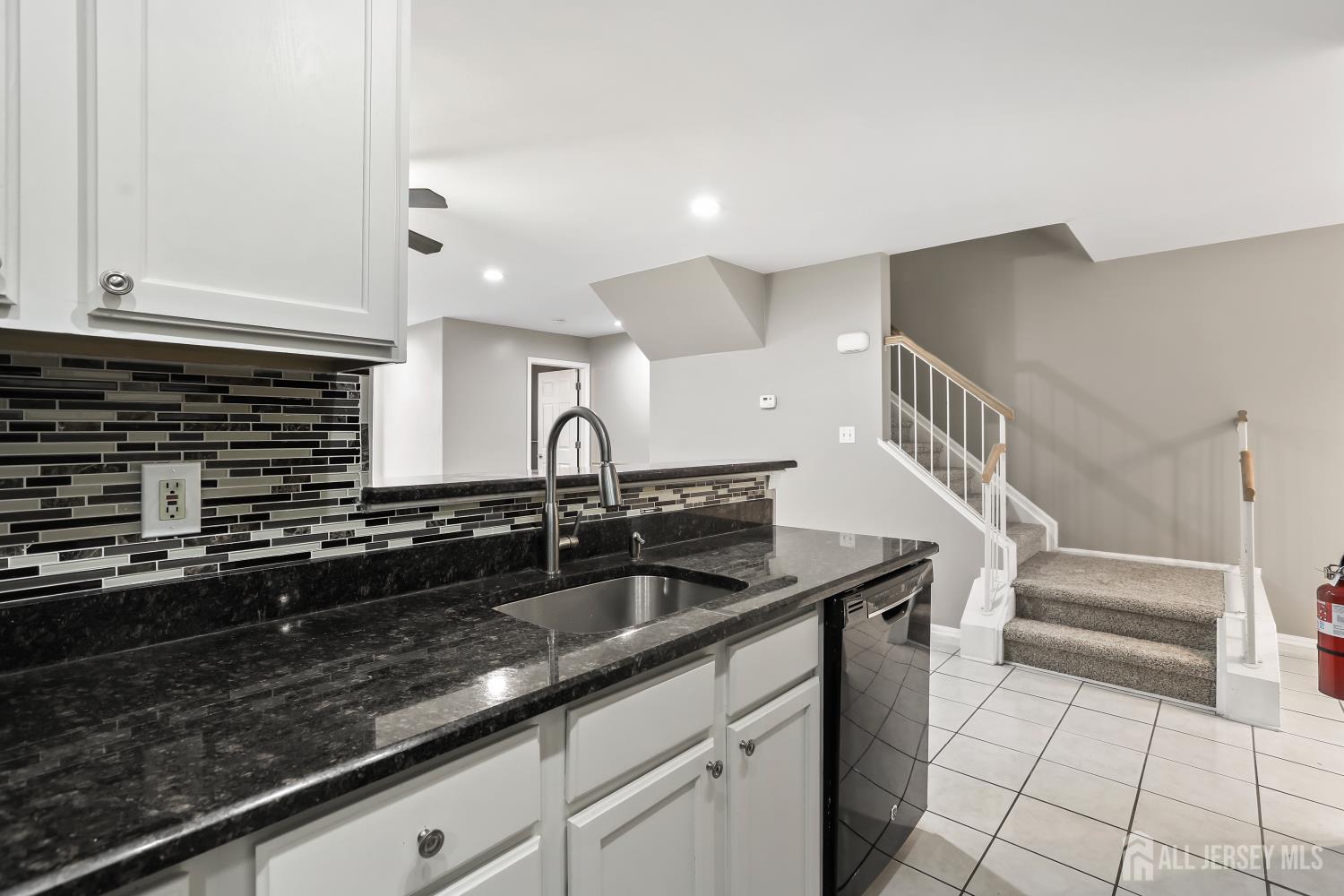1707 Ridgeview Court Sayreville, NJ 08859 - Photo 12 of 24 a kitchen with granite countertop a sink and cabinets