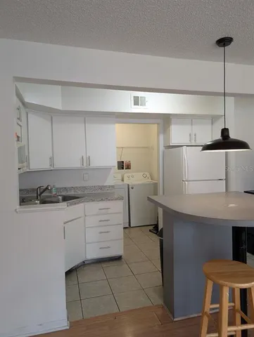 a kitchen with a sink cabinets and window