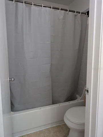 a bathroom with a shower and a toilet