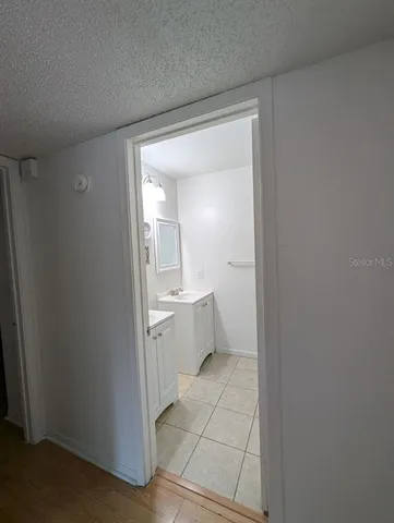 a bathroom with a sink mirror and toilet