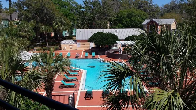 an outdoor space with seating area and trees
