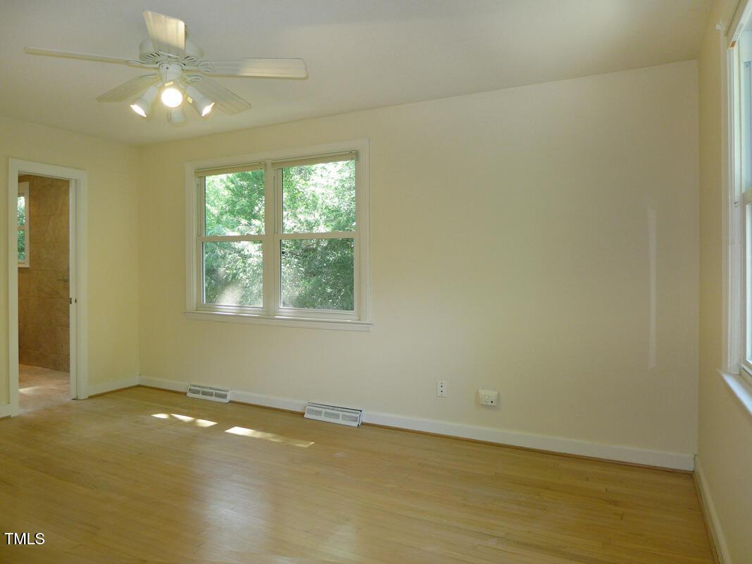 346 Wesley Drive Chapel Hill, NC 27516 - Photo 13 of 24 an empty room with a window and a ceiling fan