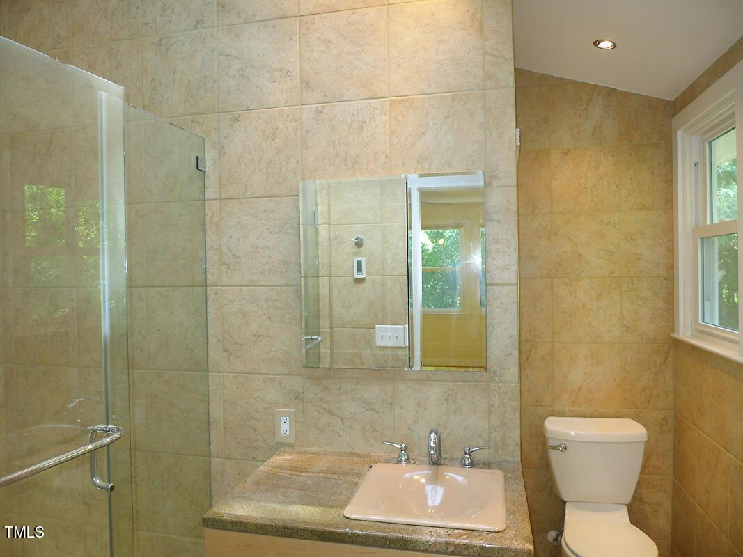 346 Wesley Drive Chapel Hill, NC 27516 - Photo 14 of 24 a bathroom with a toilet a sink and shower