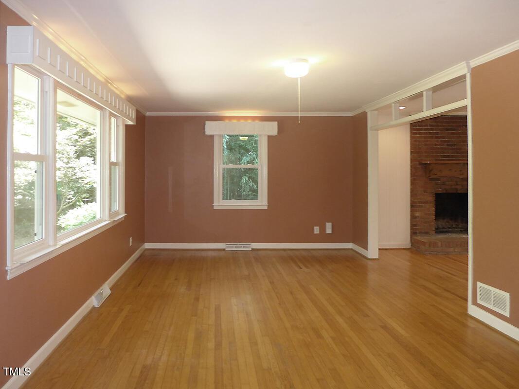 346 Wesley Drive Chapel Hill, NC 27516 - Photo 3 of 24 an empty room with wooden floor and windows